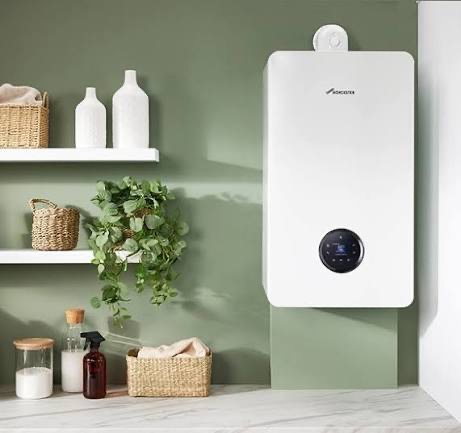 Worcester Bosch combi boiler mounted on a sage-green wall in a stylish modern utility room